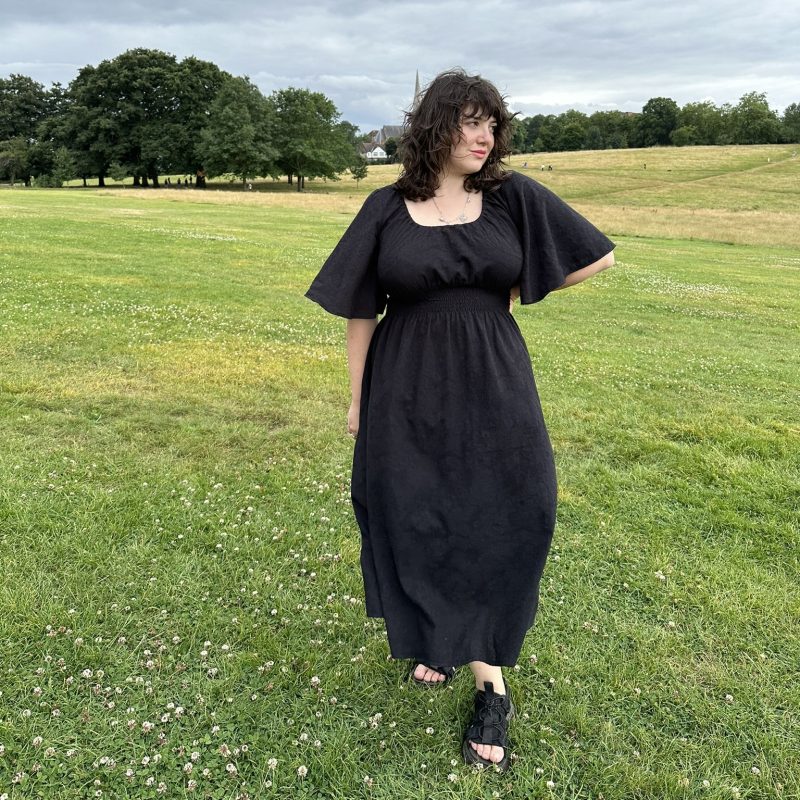 black cotton dress with 70s bell sleeves